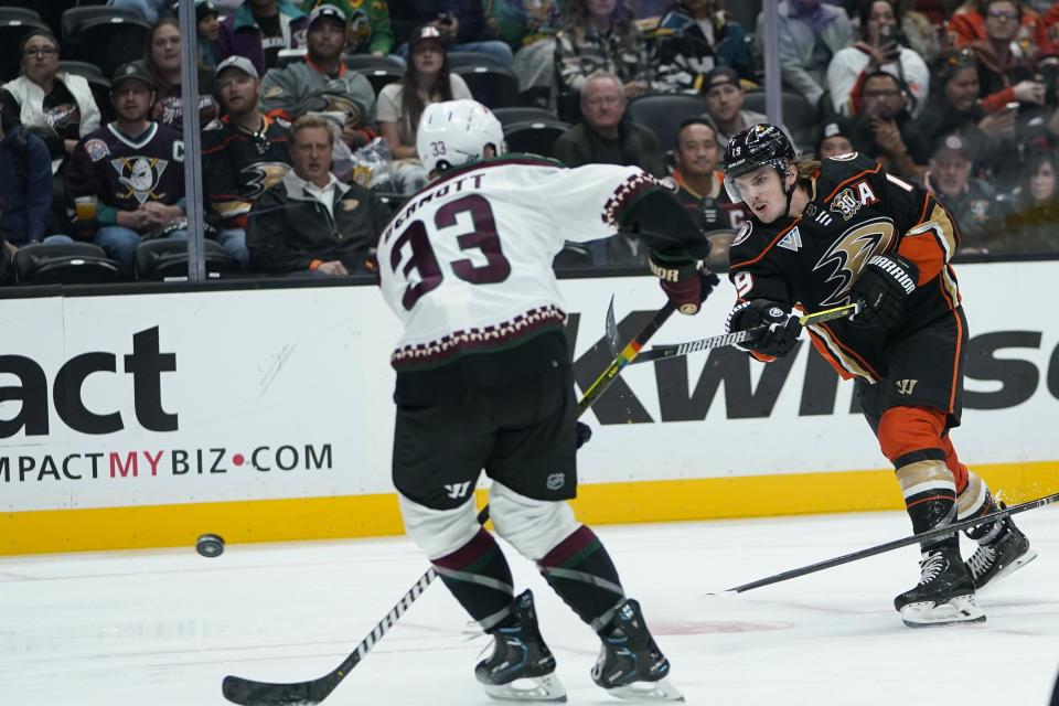 Anaheim Ducks right wing Troy Terry, right, shoots past Arizona Coyotes defenseman Travis Dermott for a goal during the first period of an NHL hockey game Wednesday, Nov. 1, 2023, in Anaheim, Calif. (AP Photo/Ryan Sun)