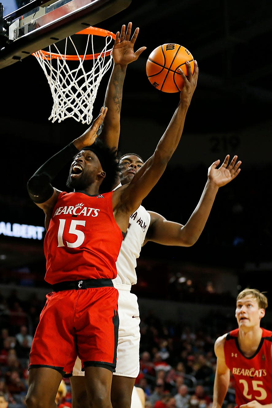 Alabama A&M Bulldogs forward Jalen Johnson (5) blocks a layup by Cincinnati Bearcats forward John Newman III (15) in the second half of the NCAA basketball game between the Cincinnati Bearcats and the Alabama A&M Bulldogs at Fifth Third Arena in Cincinnati on Tuesday, Nov. 16, 2021. The Bearcats improved to 3-0 with an 89-66 win over the Bulldogs. 