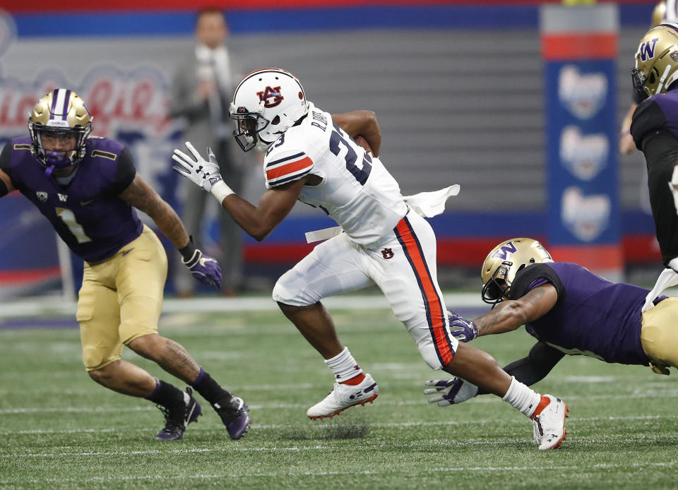 Auburn wide receiver Ryan Davis (23) breaks away from Washington defensive back Austin Joyner (4) as he returns a punt for a big gain in the first half of an NCAA college football game Saturday, Sept. 1, 2018, in Atlanta. (AP Photo/John Bazemore)