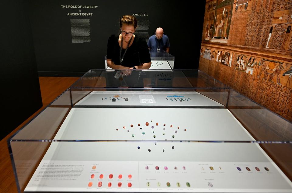 Worcester Art Museum's Objects Conservator Paula Artal-Isbrand and Education Programming Coordinator Neal Bourbeau look over amulets at WAM's new exhibition, "Jewels of the Nile."