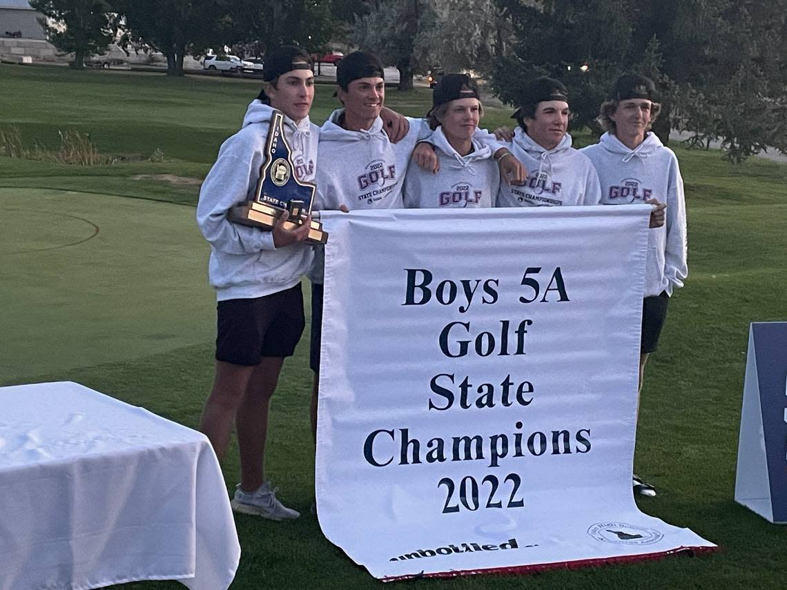 The Eagle High boys golf team poses with ther 5A state championship trophy and banner Saturday at Teton Lakes Golf Course in Rexburg.