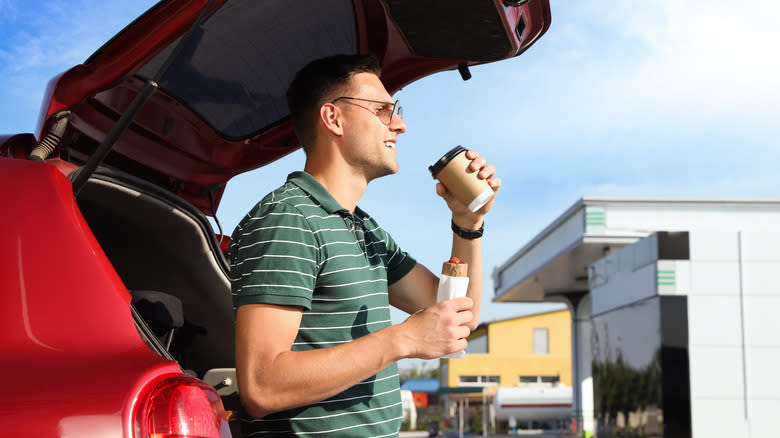 Person eating hotdog outside