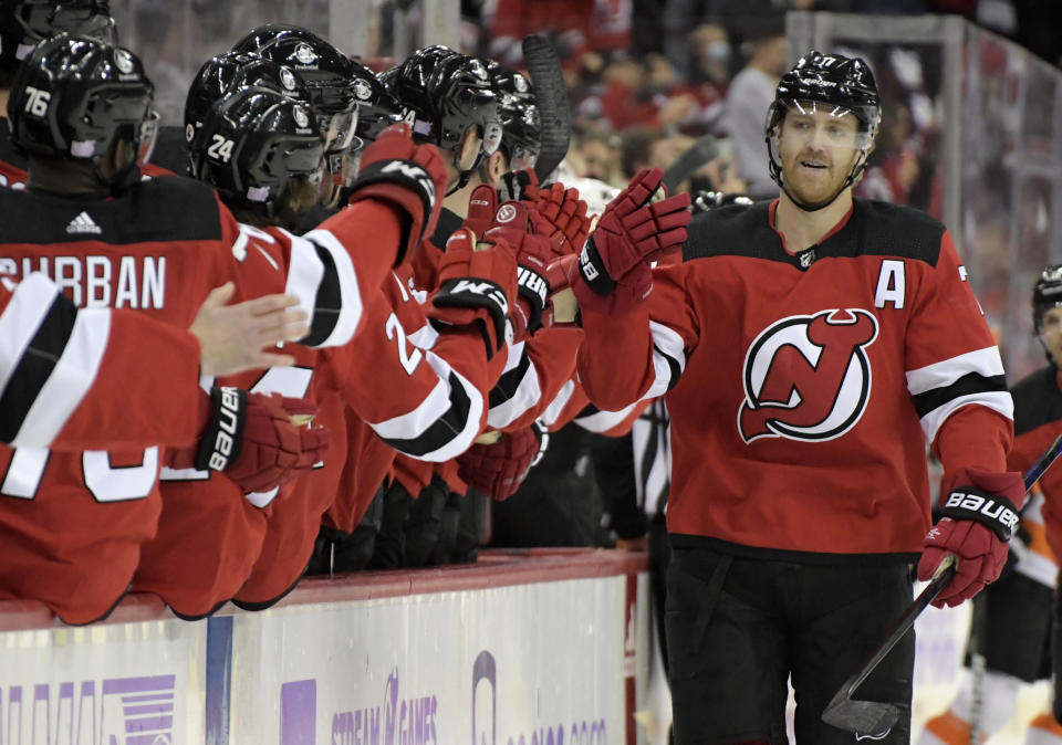 New Jersey Devils defenseman Dougie Hamilton, right, celebrates his goal with teammates during the first period of an NHL hockey game against the Philadelphia Flyers Sunday, Nov. 28, 2021, in Newark, N.J. (AP Photo/Bill Kostroun)