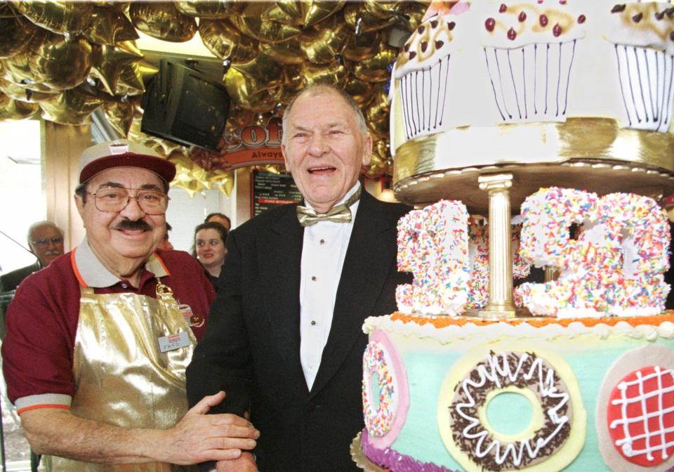 Dunkin' Donuts founder Bill Rosenberg, right, poses with Dunkin' Donuts pitchman Michael Vale, left, Wednesday, March 1, 2000, in Boston, during a 50th anniversary celebration for Dunkin' Donuts.  (AP Photo/Angela Rowlings)