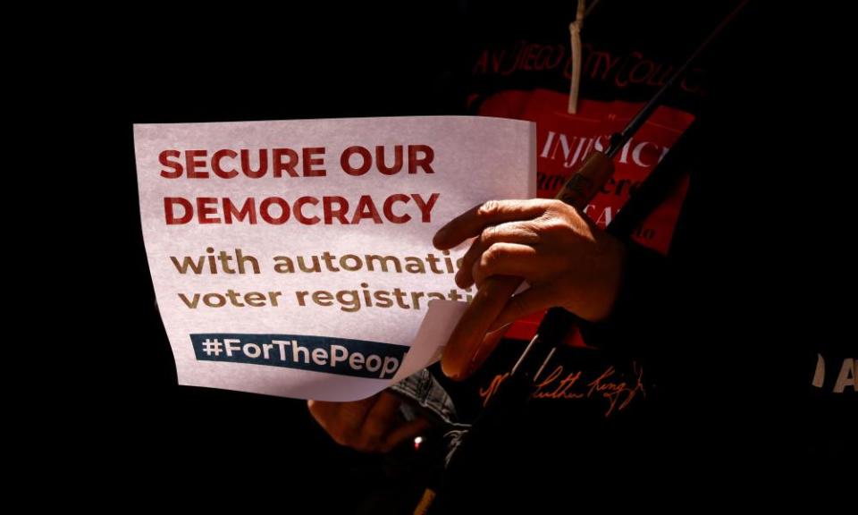 A person holds a sign reading ‘Secure our democracy’ in San Diego, California, in April.