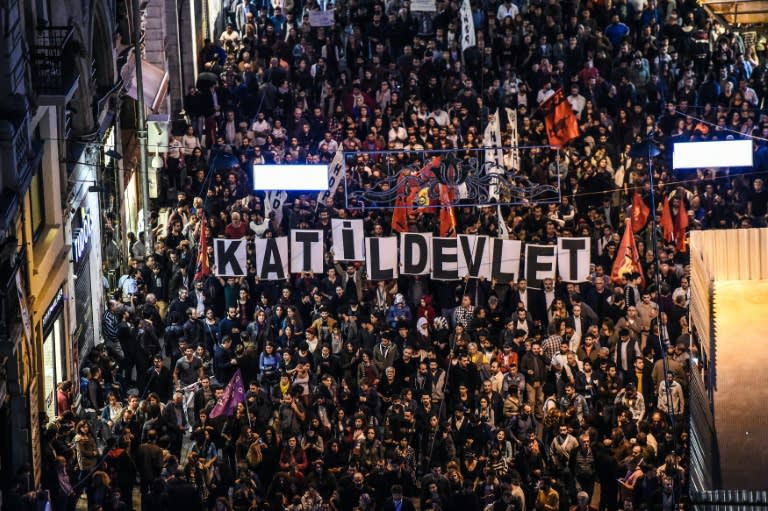 Signs reading "Killer state" are seen as thousands of protesters take part in a march against the deadly attack earlier in Ankara on October 10, 2015 on Istiklal avenue in Istanbul