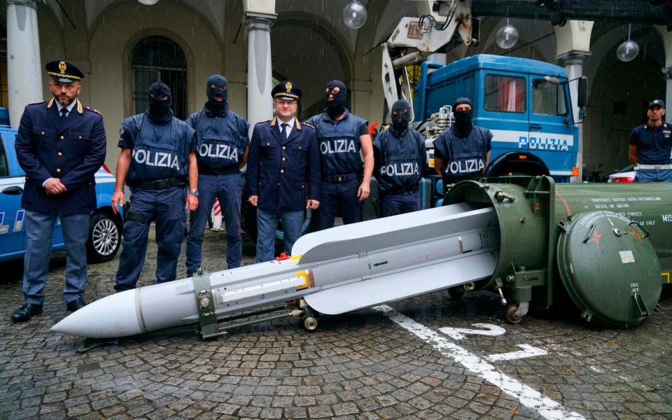 Police stand by a missile seized at an airport hangar near Pavia, northern Italy - ANSA