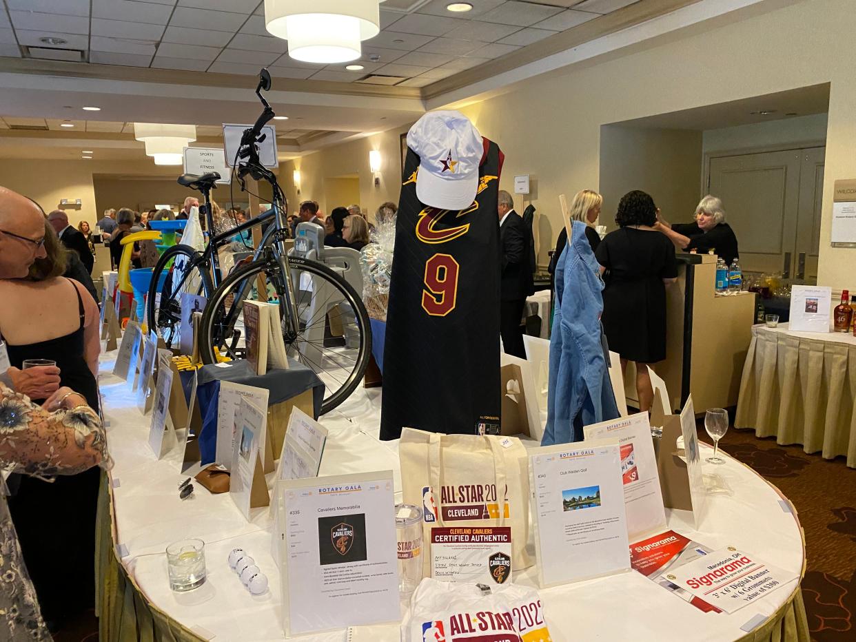 Silent auction offerings at the Rotary Gala included a bike and Cavaliers items.