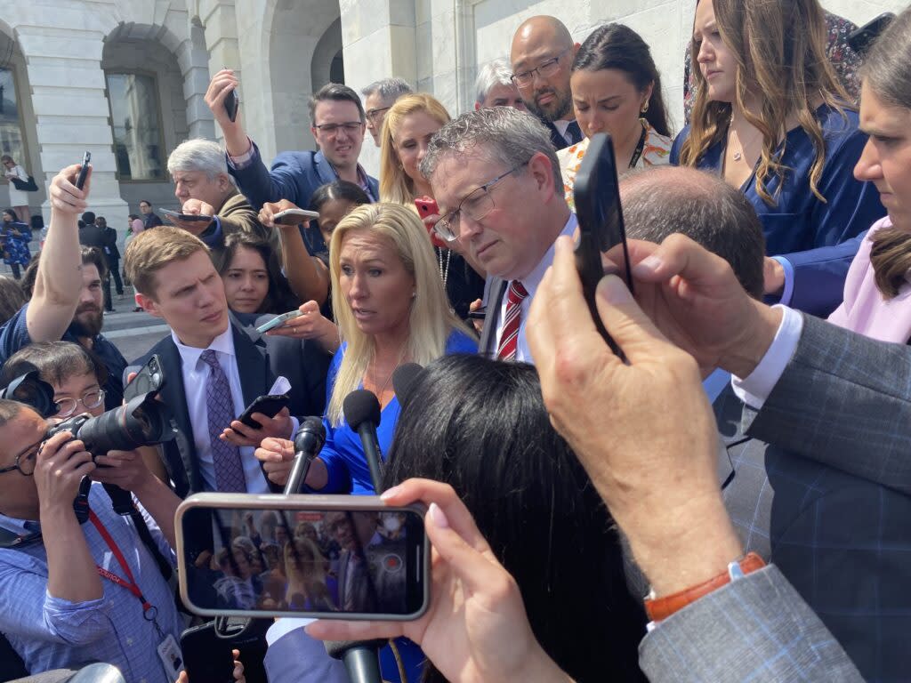 U.S. Rep. Marjorie Taylor Greene of Georgia and Rep. Thomas Massie of Kentucky both Republicans, speak to reporters on the steps of the U.S. Capitol.