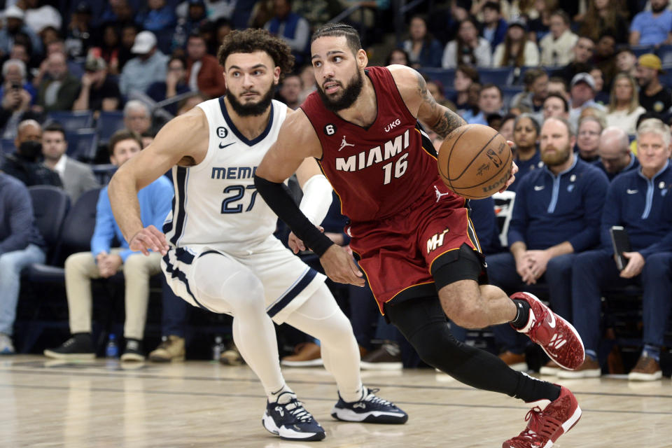 Miami Heat forward Caleb Martin (16) drives ahead of Memphis Grizzlies guard David Roddy (27) in the second half of an NBA basketball game, Monday, Dec. 5, 2022, in Memphis, Tenn. (AP Photo/Brandon Dill)