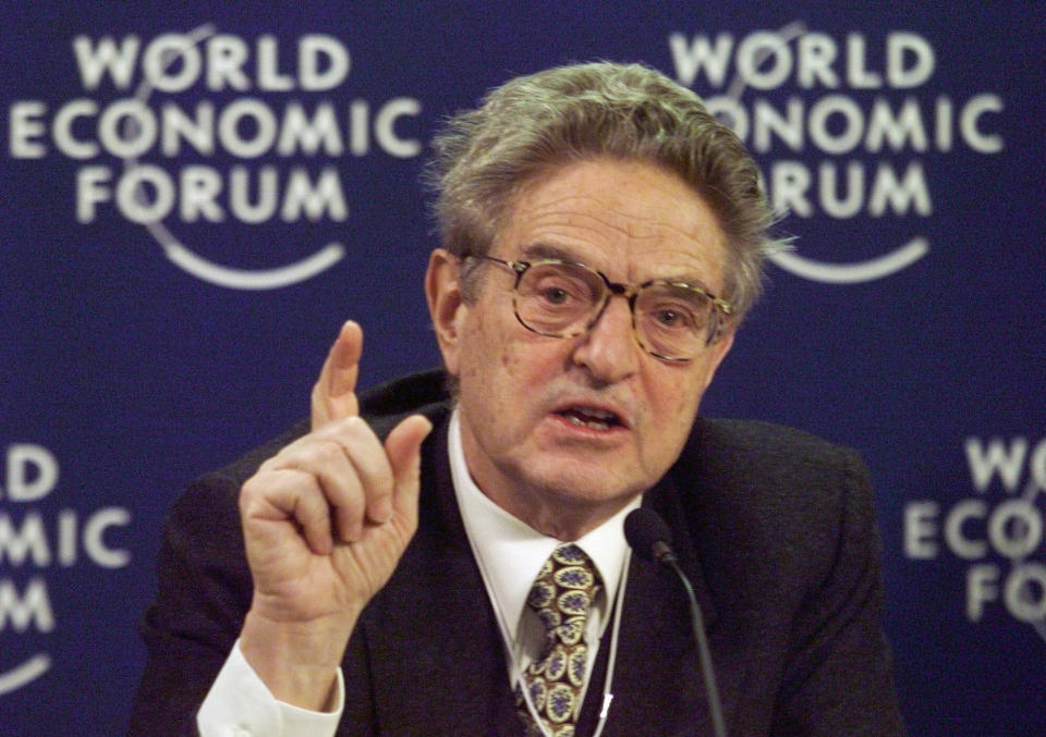 FILE - In this Monday, Feb. 1, 1999 file photo, U.S. financier George Soros speaks during a press conference at the World Economic Forum in Davos, Switzerland. The mail bomb that showed up in the mail box of billionaire investor and philanthropist George Soros on Oct. 22, 2018 is a reminder of his place as one of the far right’s most hated boogeymen. (AP Photo/Michel Euler)