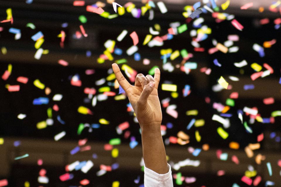 A Texas player holds up her Hook 'em sign after Sunday's win over Baylor. The Bears had beaten the Longhorns in 27 of their previous 28 meetings, and Texas hadn't won a Big 12 championship since 2003.