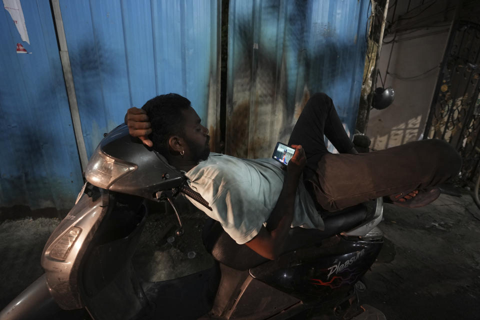 A cricket fan watches the live coverage of the ICC Men's T20 World Cup final match between India and South Africa being played in Bridgetown, Barbados, in Hyderabad, India, Saturday, June 29, 2024. (AP Photo/Mahesh Kumar A.)