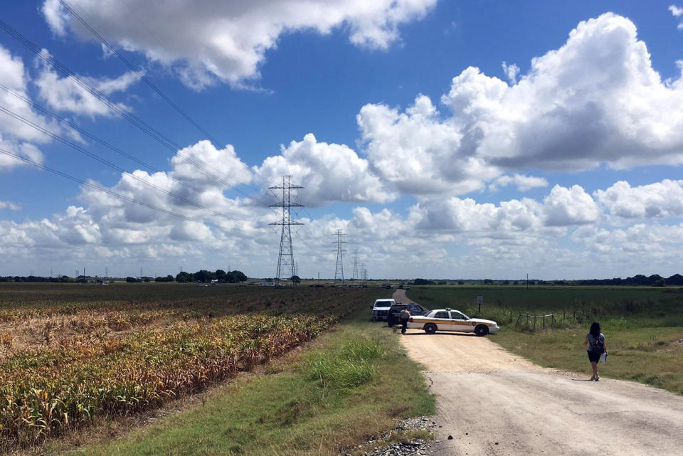 <p>Police cars block access to the site where a hot air balloon crashed early Saturday, July 30, 2016, near Lockhart, Texas. At least 16 people were on board the balloon, which Federal Aviation Administration spokesman Lynn Lunsford said caught fire before crashing into a pasture shortly after 7:40 a.m. Saturday near Lockhart. No one appeared to survive the crash, authorities said. (AP Photo/James Vertuno) </p>