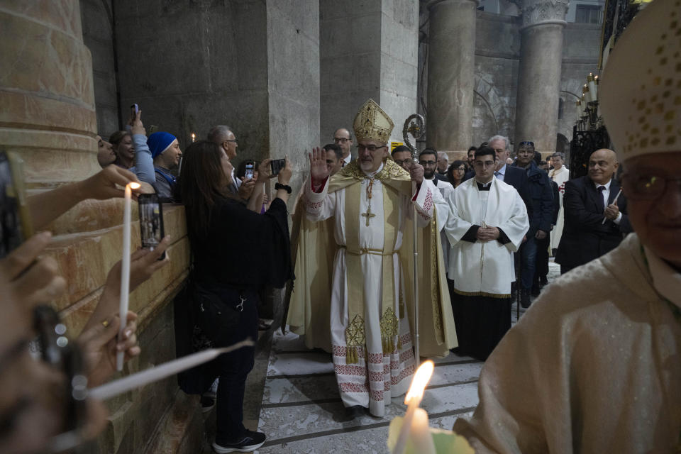 Latin Patriarch of Jerusalem Pierbattista Pizzaballa walk in a precession around the Edicule during Easter Sunday Mass at the Church of the Holy Sepulchre, where many Christians believe Jesus was crucified, buried and rose from the dead, in the Old City of Jerusalem, Sunday, March 31, 2024. (AP Photo/Leo Correa)