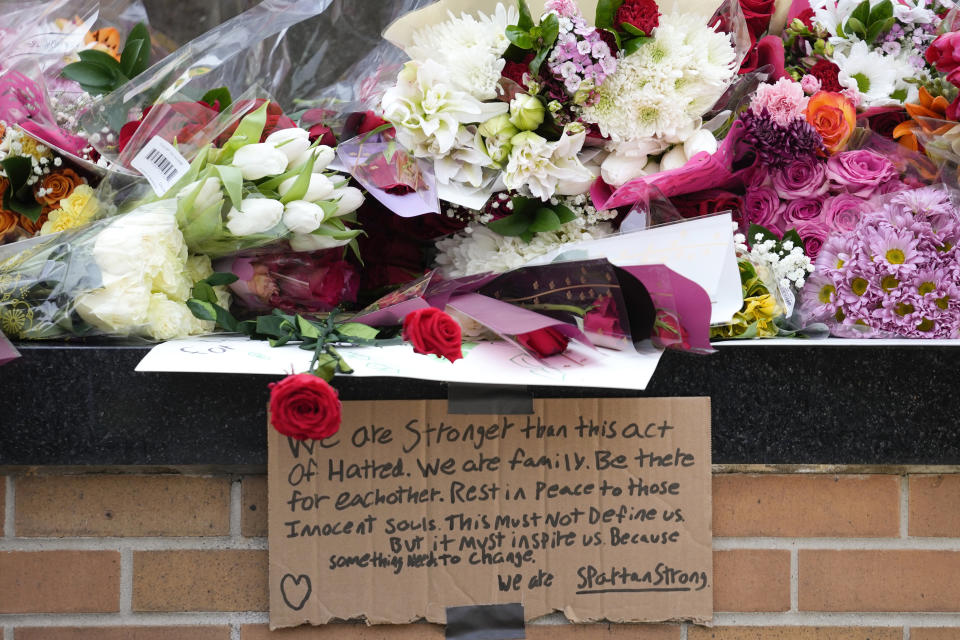 Flowers are left at the Spartan Statue on the grounds of Michigan State University, in East Lansing, Mich., Tuesday, Feb. 14, 2023. A gunman killed several people and wounded others at Michigan State University. Police said early Tuesday that the shooter eventually killed himself. (AP Photo/Paul Sancya)