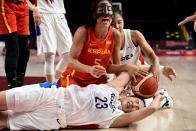 <p>Spain's Cristina Ouvina (C) reacts as she fights for the ball with South Korea's Kim Danbi (bottom) in the women's preliminary round group A basketball match between South Korea and Spain during the Tokyo 2020 Olympic Games at the Saitama Super Arena in Saitama on July 26, 2021. (Photo by Aris MESSINIS / AFP)</p> 