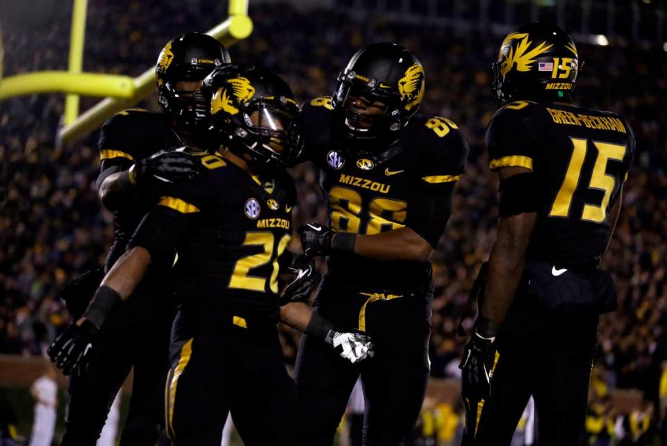 Missouri running back Henry Josey (20) is congratulated by teammates after scoring on a 57-yard run during the fourth quarter of an NCAA college football game against Texas A&M on Saturday, Nov. 30, 2013, in Columbia, Mo. (AP Photo/Jeff Roberson)