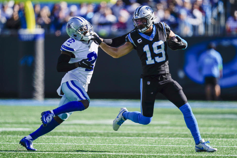 Carolina Panthers wide receiver Adam Thielen runs around Dallas Cowboys cornerback Jourdan Lewis during the first half of an NFL football game Sunday, Nov. 19, 2023, in Charlotte, N.C. (AP Photo/Erik Verduzco)