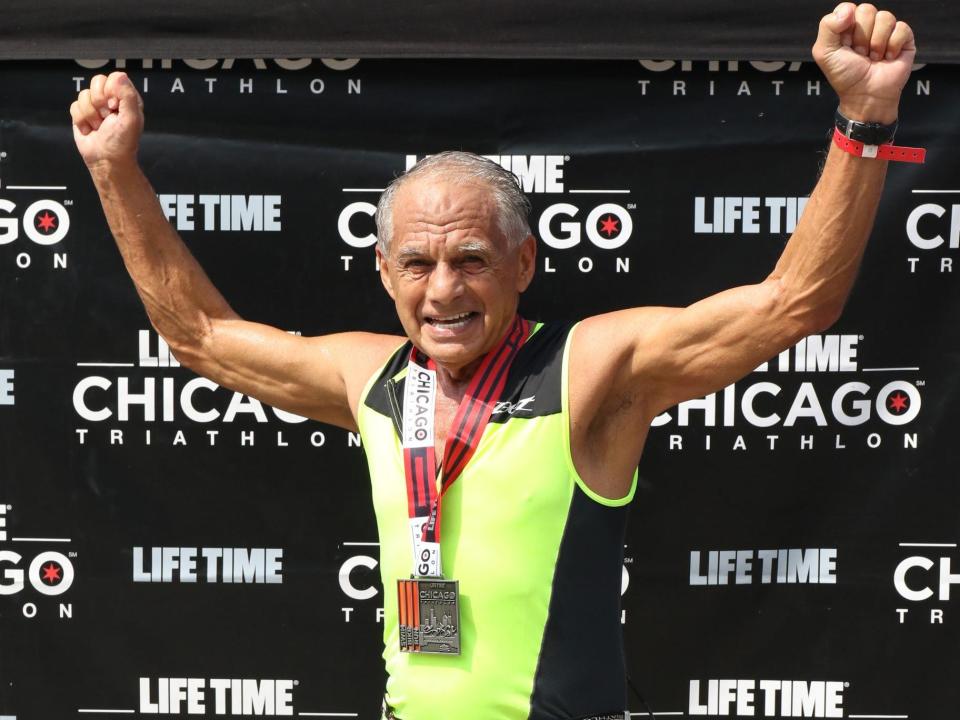 Dr. Joseph Maroon raises his fists in victory at the Lifetime Chicago Triathlon.