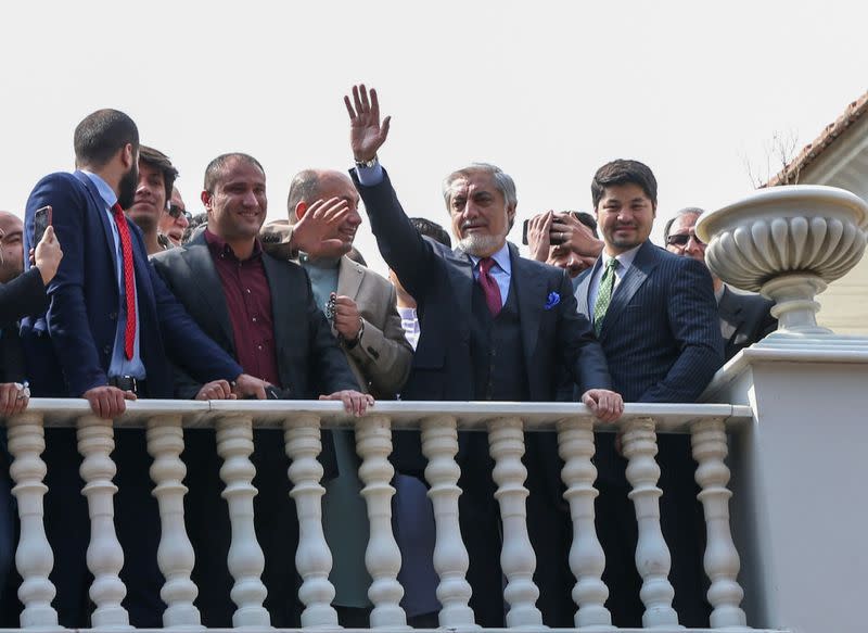 Afghanistan's former CEO Abdullah Abdullah, gestures to supporters before his swearing-in ceremony as a president, in Kabul