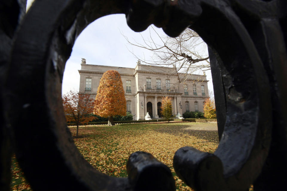 This Nov. 19, 2010 file photo shows the Elms mansion as seen through an opening in an iron fence, in Newport, R.I.  Newly discovered photographs, documents and family histories have inspired the creation of a tour about servants at The Elms, echoing themes of the British drama program,