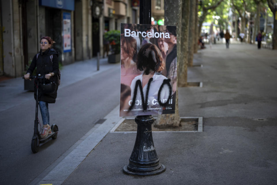 A flagged electoral posters showing Barcelona's candidate for the next elections Ada Colau, is photographed in Barcelona, Spain, Wednesday, May 24, 2023. Spain goes to the polls on Sunday for local and regional elections seen as a bellwether for a national vote in December, with the conservative Popular Party (PP) steadily gaining ground on the ruling Socialists in key regions. (AP Photo/Emilio Morenatti)