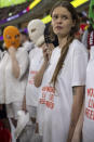 A group of young women, some, wearing colorful balaclavas who identified themselves as members of the Pussy Riot collective in the stands during the World Cup group B soccer match between Iran and the United States at the Al Thumama Stadium in Doha, Qatar, Tuesday, Nov. 29, 2022. (AP Photo/Ciaran Fahey)