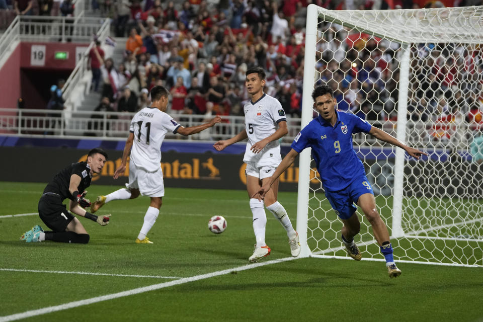 Thailand's Supachai Chaided, right, celebrates after scoring the opening goal during the Asian Cup Group F soccer match between Kyrgyzstan and Thailand at Abdullah Bin Khalifa Stadium in Doha, Qatar, Tuesday, Jan. 16, 2024. (AP Photo/Thanassis Stavrakis)