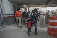 A migrant family crosses the border into El Paso, Texas, in Ciudad Juarez, Mexico, Friday, Feb. 26, 2021. After waiting months and sometimes years in Mexico, people seeking asylum in the United States are being allowed into the country as they wait for courts to decide on their cases, unwinding one of the Trump administration's signature immigration policies that President Joe Biden vowed to end. (AP Photo/Christian Chavez)