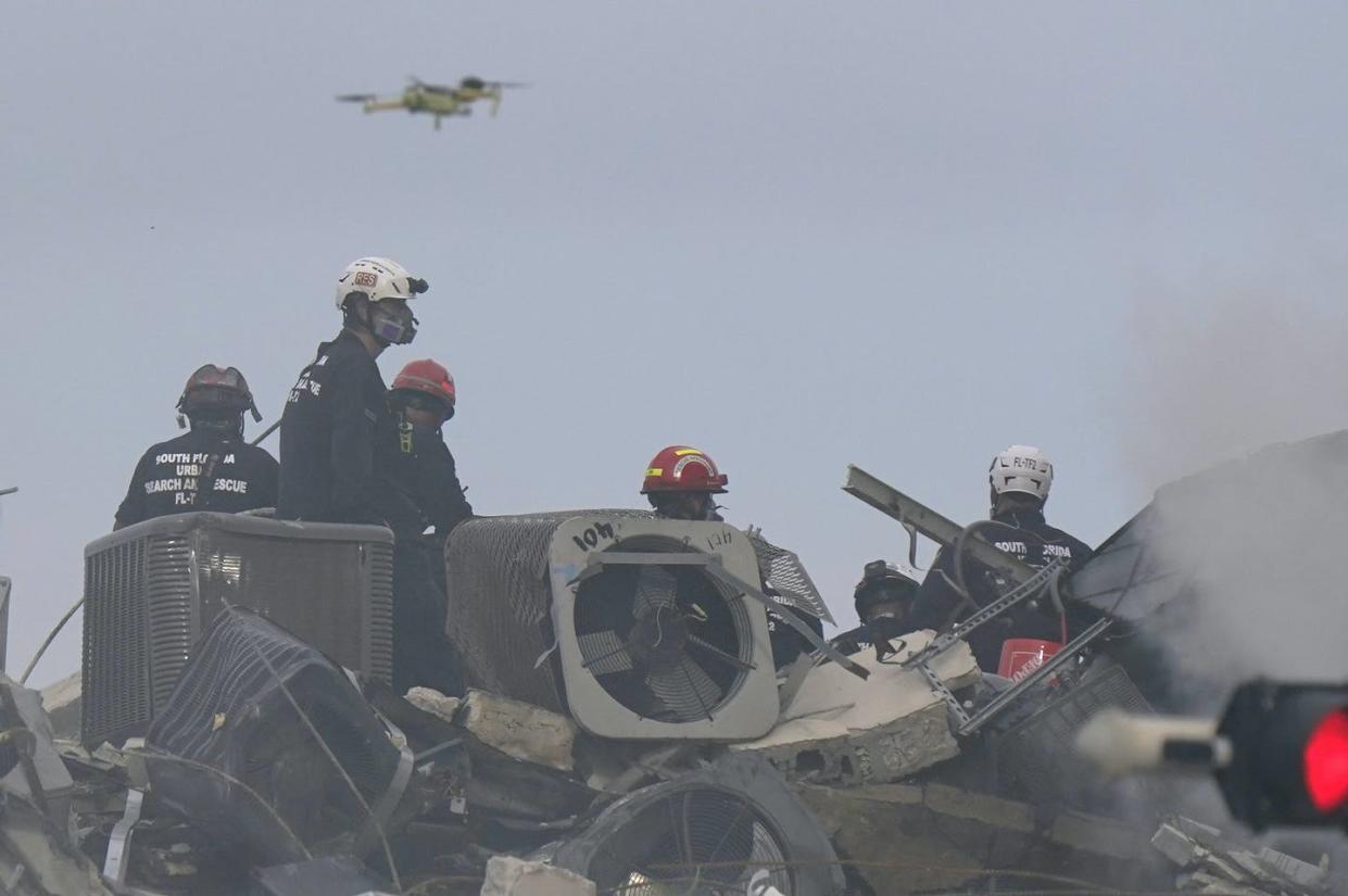 <span class="caption">A drone flies above search and rescue personnel at the site of the Champlain Towers South Condo building collapse in Surfside, Florida.</span> <span class="attribution"><a class="link " href="https://newsroom.ap.org/detail/BuildingCollapseMiami/c1b6b4c886da46aaa5d6bad1fa2624bf/photo" rel="nofollow noopener" target="_blank" data-ylk="slk:AP Photo/Wilfredo Lee;elm:context_link;itc:0;sec:content-canvas">AP Photo/Wilfredo Lee</a></span>