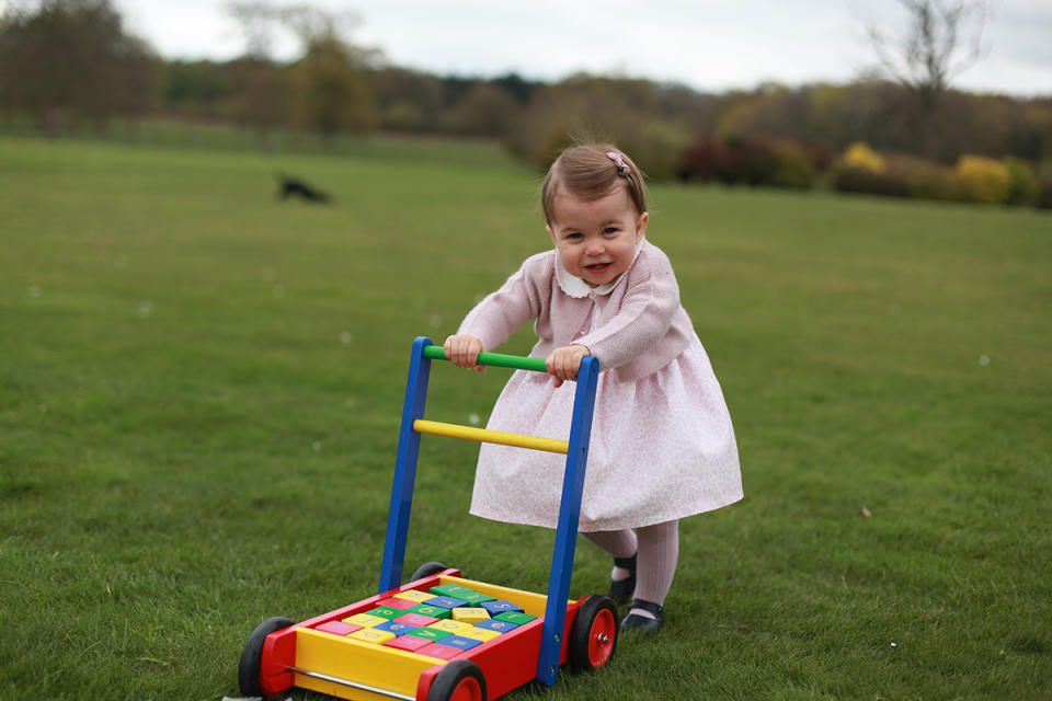 <p>The young royal pushes a toy around in her yard in another sweet photo taken by the Duchess of Cambridge.</p>