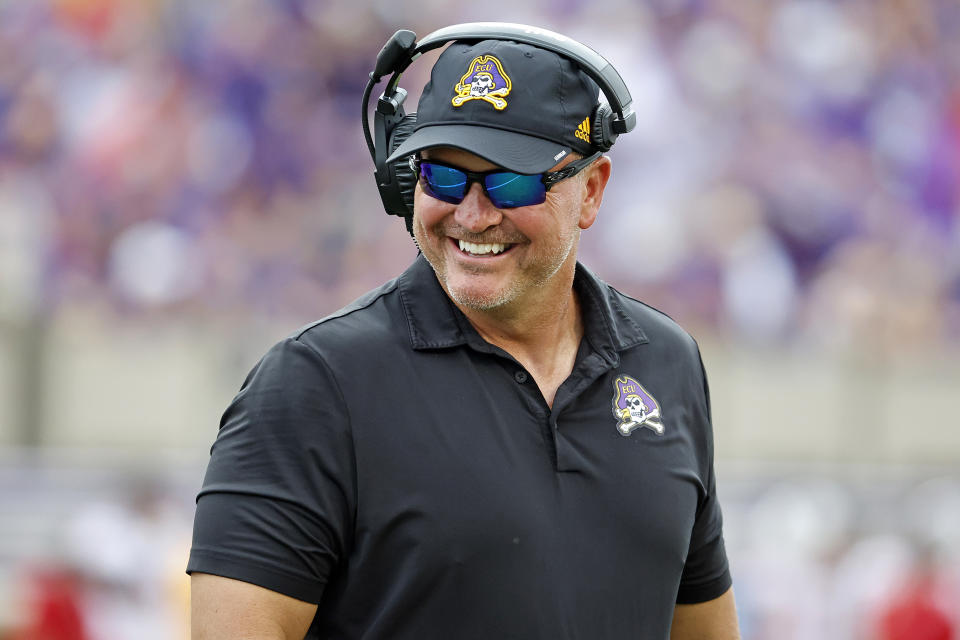 East Carolina head coach Mike Houston jokes with an official during the second half of an NCAA college football game against North Carolina State in Greenville, N.C., Saturday, Sept. 3, 2022. (AP Photo/Karl B DeBlaker)