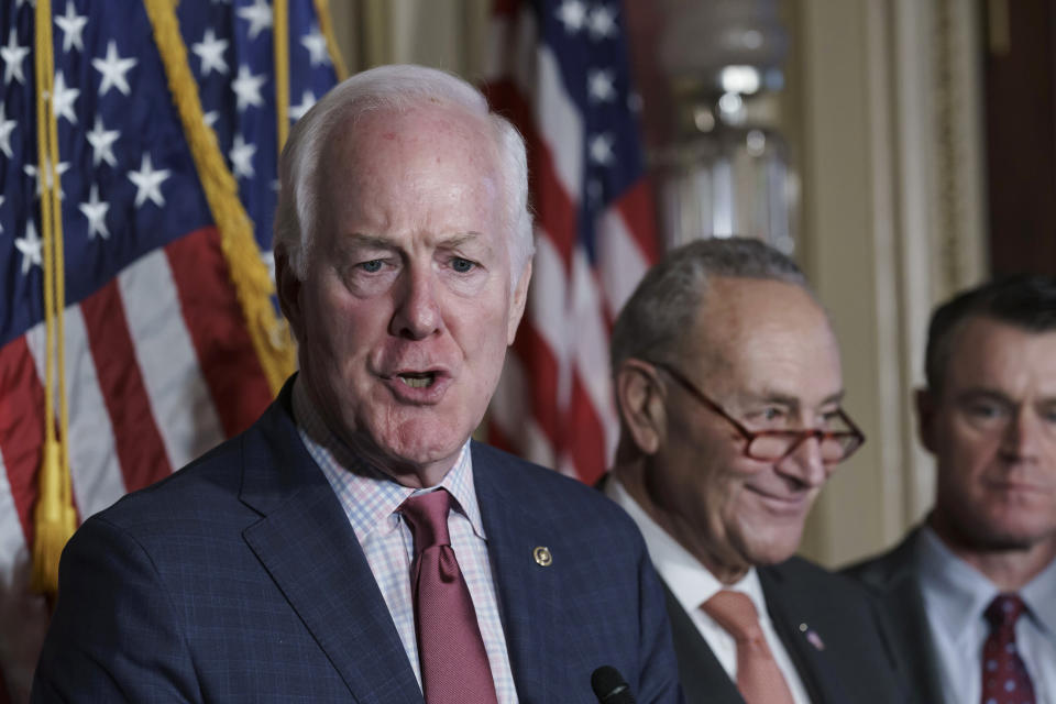 Sen. John Cornyn, R-Texas, left, joined by Senate Majority Leader Chuck Schumer, D-N.Y., and Sen. Todd Young, R-Ind., praises the bipartisan effort to pass a bill designed to encourage more semiconductor companies to build chip plants in the United States, at the Capitol in Washington, Wednesday, July 27, 2022. The $280 billion measure, which awaits a House vote, includes federal grants and tax breaks for companies that construct their chip facilities in the U.S. (AP Photo/J. Scott Applewhite)