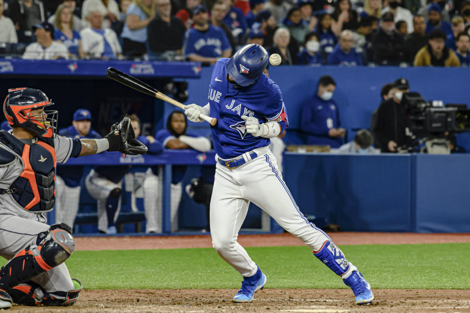 Toronto Blue Jays' Lourdes Gurriel Jr. (13) is hit by a Houston Astros pitch during the seventh inning of a baseball game Friday, April 29, 2022, in Toronto. (Christopher Katsarov/The Canadian Press via AP)