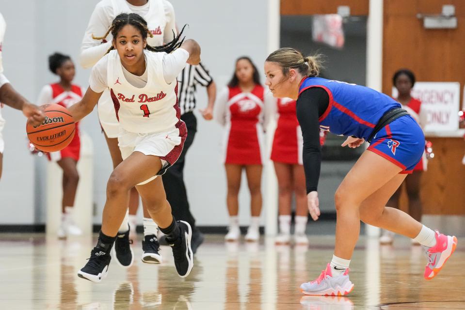 Pike Red Devils guard Saniya Smith (1) rushes up the court against Roncalli Royals Sara Rosko (3) on Tuesday, Nov. 14, 2023, during the game at Pike High School in Indianapolis.