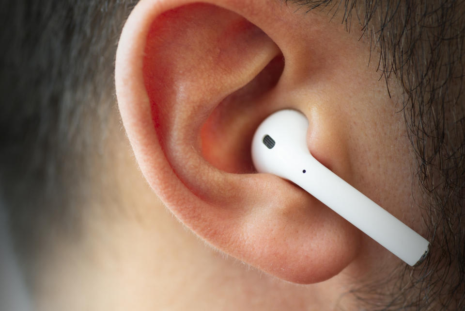 Izmir, Turkey - July  12, 2019: Close up shot of the one of Apple brand airpods on a caucasian white males ear.
