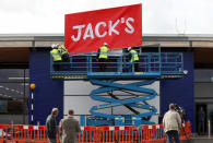 Workers unveil the branding at Tesco's new discount supermarket Jack's, in Chatteris, Britain, September 19, 2018. REUTERS/Chris Radburn
