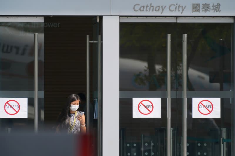 Woman wearing a mask following the coronavirus disease (COVID-19) outbreak, walks out of Cathay City, the headquarters of Cathay Pacific, in Hong Kong