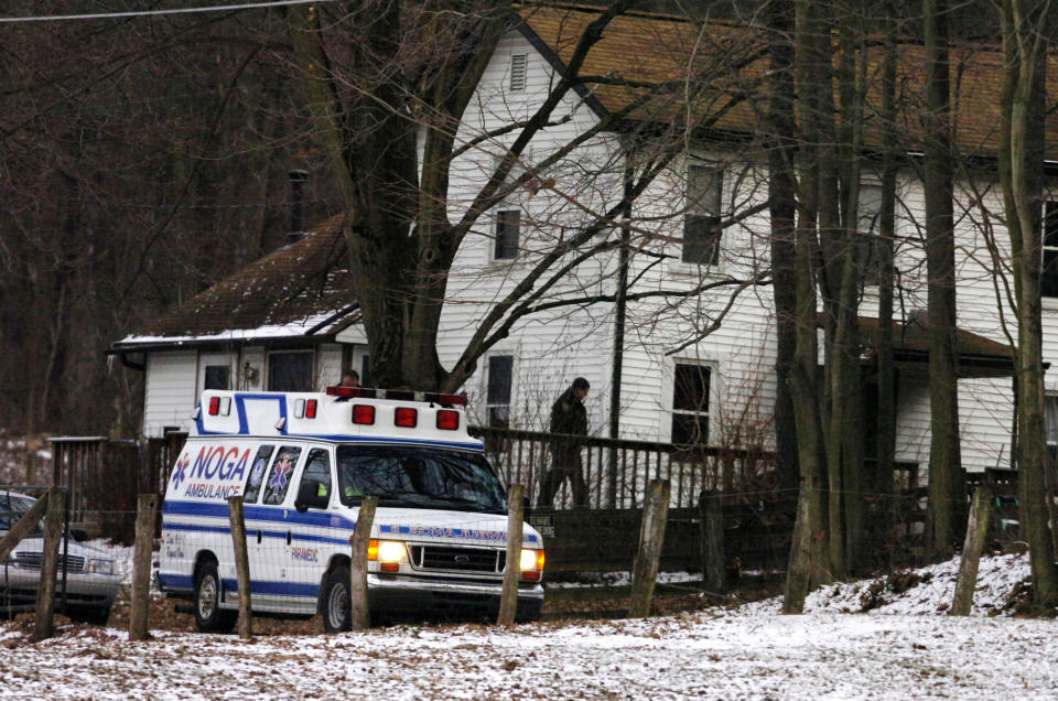 FILE - In this file photo from Feb. 21, 2009, an ambulance is parked outside the farmhouse where Kenzie Marie Houk was killed in Wampum, Pa. Jordan Brown, who was eleven-years-old at the time was charged in the shooting death of the 26-year-old pregnant mother of two. He is now filing a wrongful prosecution and conviction lawsuit, alleging that the state police investigators knowingly disobeyed protocols, fabricated and manipulated evidence to further a fake narrative that he was guilty. (AP Photo/Beaver County Times, Kevin Lorenzi, File)