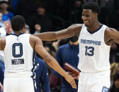 Memphis Grizzlies guard De'Anthony Melton (0) is congratulated by teammate Jaren Jackson Jr. (13) after an NBA basketball game against the Dallas Mavericks, Saturday, Dec. 4, 2021, in Dallas. (AP Photo/Sam Hodde)