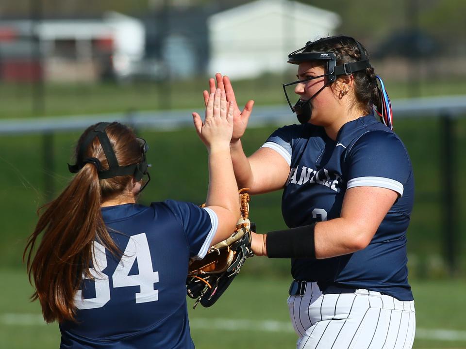 Granville pitcher Ally Ernsberger is congratulated by third baseman Emily Travis after recording an out against Watkins Memorial on Thursday.