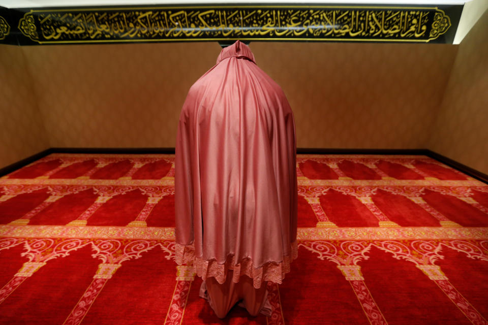 A Muslim woman prays at the Al Meroz hotel in Bangkok