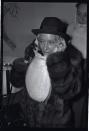 <p>Legendary film star, Gloria Swanson, dresses the part for Christmas with a Santa wig while attending a holiday party. </p>