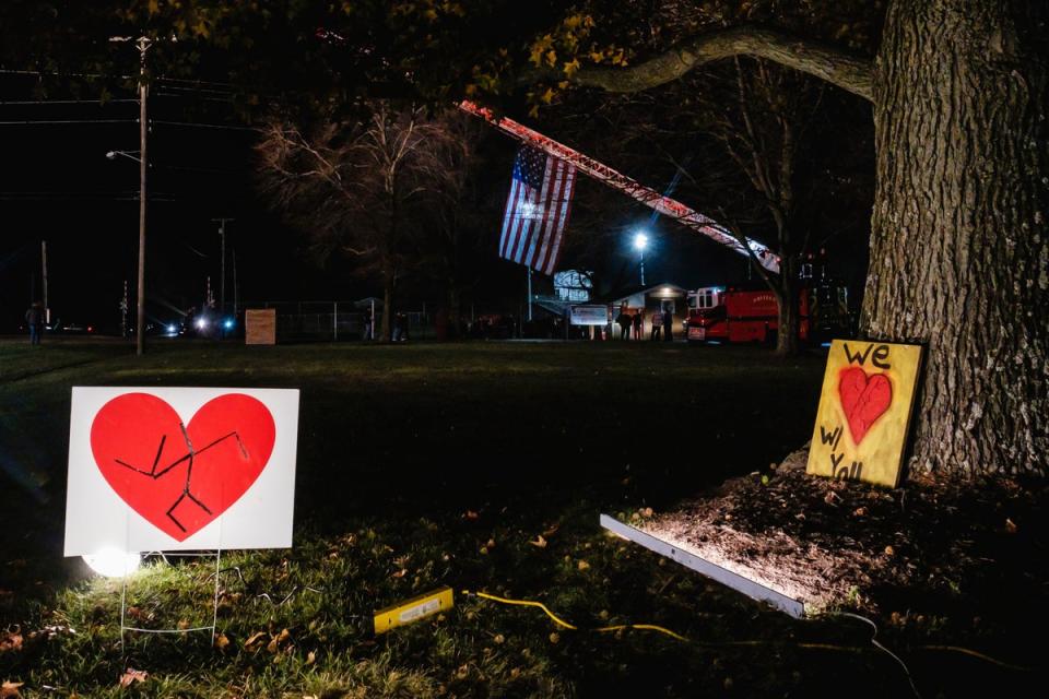 Signs in support of the Tusky Valley Schools community can be seen in front of the elementary school shortly before a community prayer vigil (AP)