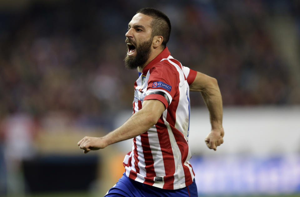 Atletico's Arda Turan celebrates scoring his side's second goal during a Champions League, round of 16, second leg, soccer match between Atletico Madrid and AC Milan at the Vicente Calderon stadium in Madrid, Tuesday March 11, 2014. (AP Photo/Paul White)