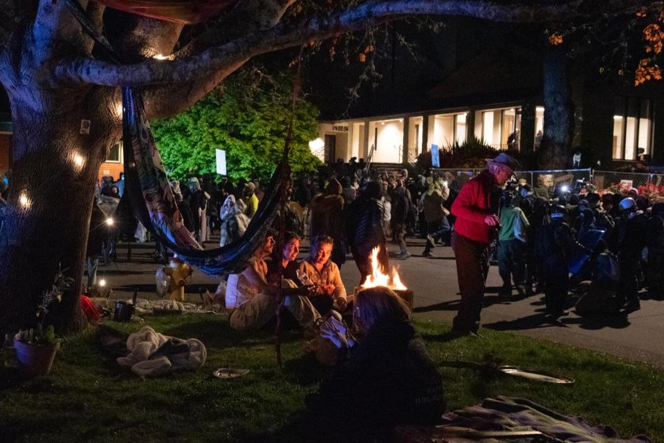 Student protesters gather around a campfire at Cal Poly Humboldt.