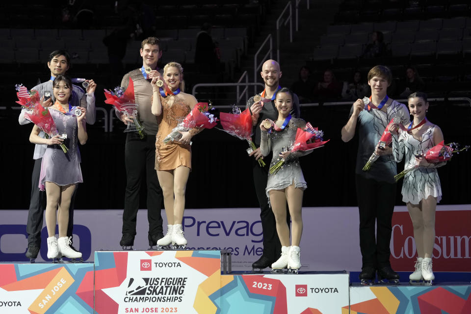 Spencer Howe, Emily Chan, Brandon Frazier, Alexa Knierim, Danny O'Shea, Ellie Kam, Daniel Tioumentsev and Sonia Baram, from left, hold their medals after the pairs free skate at the U.S. figure skating championships in San Jose, Calif., Saturday, Jan. 28, 2023. Knierim and Frazier finished first, Howe and Chan finished second, Kam and O'Shea finished third, and Baram and Tioumentsev finished fourth in the event. (AP Photo/Tony Avelar)