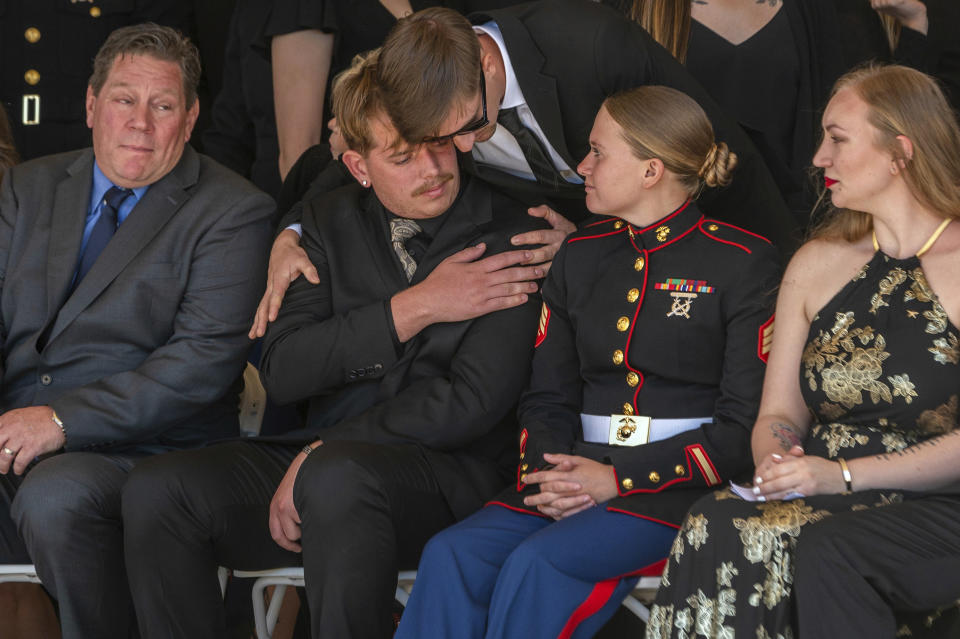 Marine Sgt. Nicole Gee's husband, Jarod Gee, second left, is comforted at her memorial at Bayside Church Adventure Campus in Roseville, Calif., Saturday, Sept. 18, 2021. Sgt. Gee lost her life, along with 12 other U.S. service members, in a bombing attack at the Kabul airport in Afghanistan on August 26. (Renee C. Byer/The Sacramento Bee via AP)