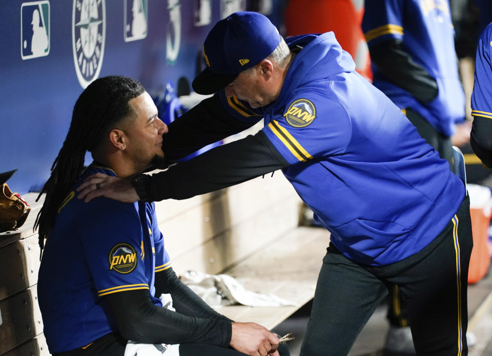 Seattle Mariners manager Scott Servais, right, talks with starting pitcher Luis Castillo, left, after the seventh inning against the Houston Astros during a baseball game Friday, May 5, 2023, in Seattle. (AP Photo/Lindsey Wasson)